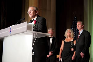 William Gahl comments after accepting the Service to America Award while DuPont's Executive Vice President and Chief Innovation Officer Thomas Connelly, Jr. (left), Sally Massagee (center) and U.S. Representative Chris Van Hollen look on. Photo by Sam Kittner Photography