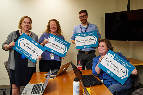 Researchers hold reddit signs