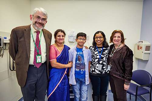  From L to R: Dan Kastner, M.D., Ph.D., Rohith's mother, Rohith Lokesh, Kalpana Manthiram, M.D., and Tina Romeo, research nurse gather at the NIH Clinical Center to discuss the patient's care. Image Credit: Ernesto del Aguila III, NHGRI