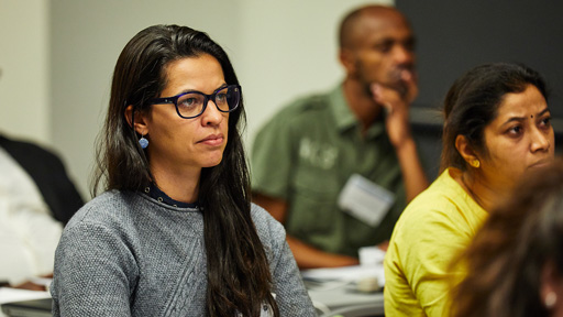 woman intently listening in a classroom setting