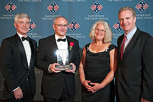 William Gahl (second from left) accepts the Service to America Award following presenter remarks by (from left) DuPont's Executive Vice President and Chief Innovation Officer Thomas Connelly, Jr., Sally Massagee and U.S. Representative Chris Van Hollen. Photo by Sam Kittner Photography.