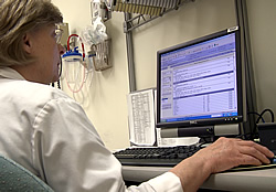 Nurse looking at electronic medical records on a computer screen