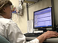 Nurse looking at electronic medical records on a computer screen