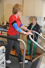 Louise Benge, Brodhead, Ky., a participant in the NIH Undiagnosed Diseases Program, is monitored while walking. Annette Stine, research coordinator, National Heart Lung and Blood Institute, NIH, monitors the treadmill test