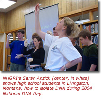 Photo of Sarah Anzick and students holding up test tubes.