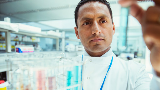 Scientist looking at tube