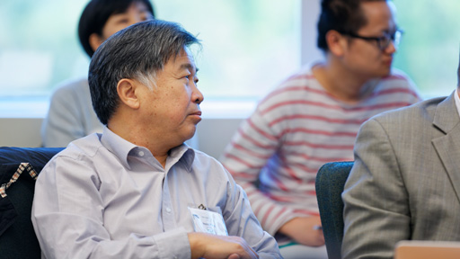 Man listening with others at meeting