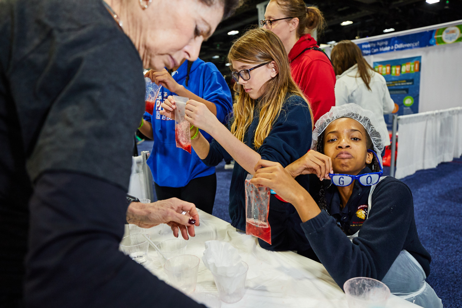 Student poses for the camera while participating in the Strawberry DNA extraction experiment