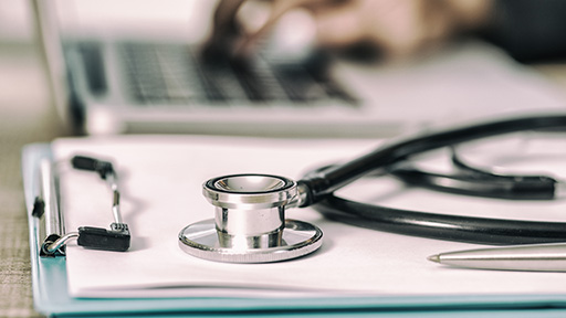 Stethoscope on a clipboard with paperwork