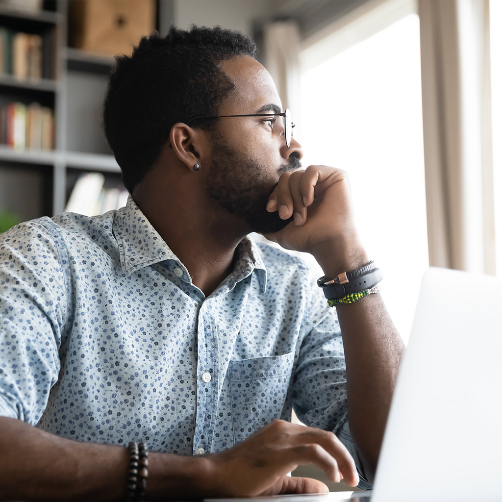 man at laptop thinking