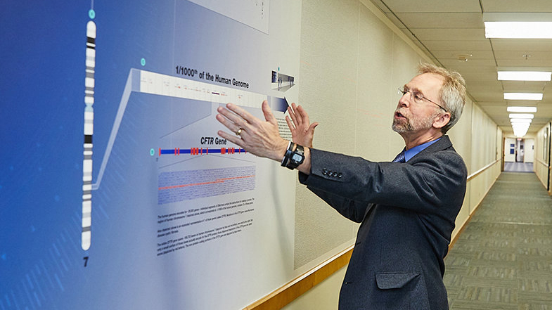 Eric Green in front of the Scale of the Human Genome Mural