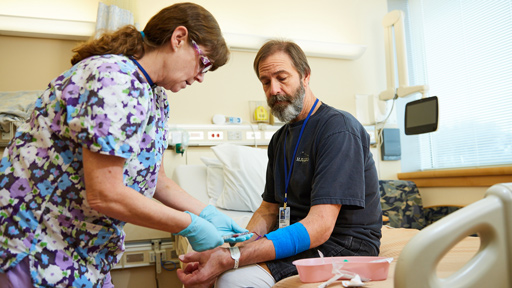 Nurse checking vitals of a male patient